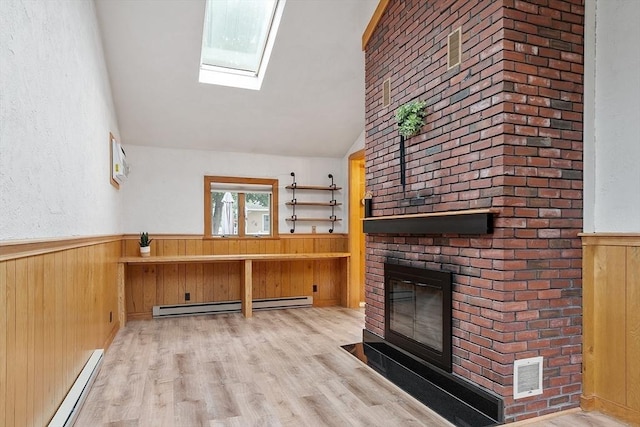 25 Ocallaghan Way, Lynn, MA 01905 - unfurnished living room with a baseboard heating unit, a wainscoted wall, a fireplace, wood walls, and lofted ceiling