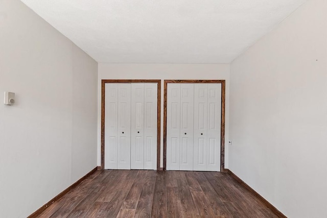 25 Ocallaghan Way, Lynn, MA 01905 - unfurnished bedroom featuring two closets and dark wood finished floors