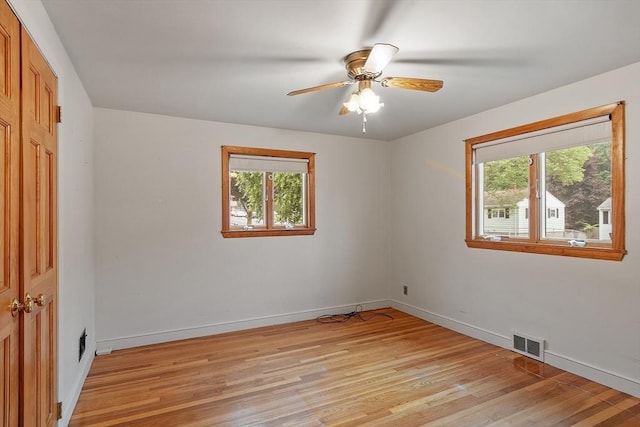 25 Ocallaghan Way, Lynn, MA 01905 - unfurnished bedroom featuring multiple windows, light wood-type flooring, and a ceiling fan