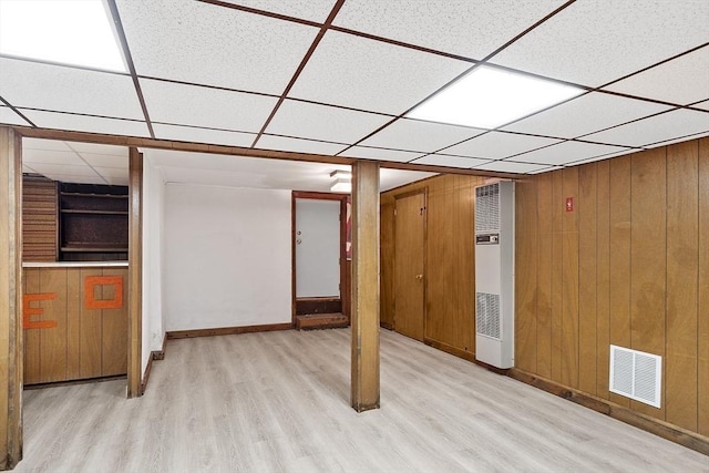 25 Ocallaghan Way, Lynn, MA 01905 - finished below grade area featuring a heating unit, light wood-style floors, a drop ceiling, and wooden walls