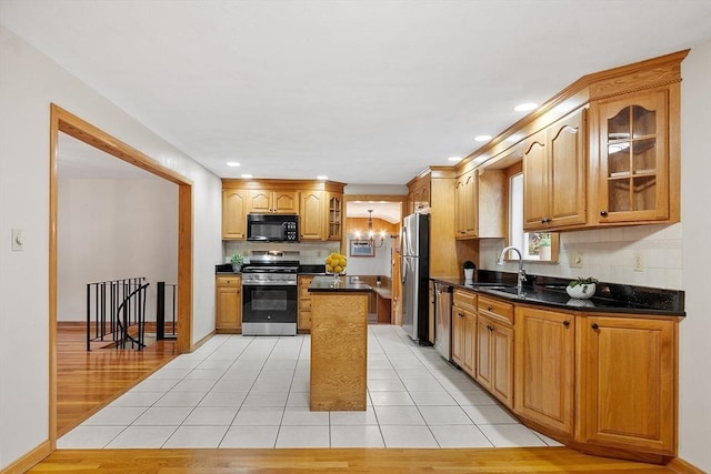 25 Ocallaghan Way, Lynn, MA 01905 - kitchen with appliances with stainless steel finishes, decorative backsplash, glass insert cabinets, light tile patterned flooring, and recessed lighting