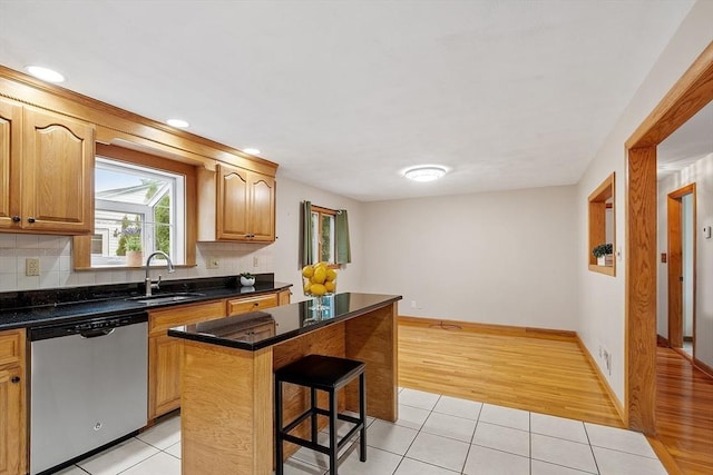 25 Ocallaghan Way, Lynn, MA 01905 - kitchen with stainless steel dishwasher, a breakfast bar, light tile patterned floors, a center island, and recessed lighting