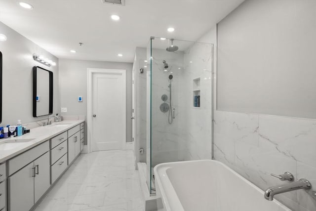 33 Commercial Wharf Unit 33A, Boston, MA 02110 - bathroom featuring a marble finish shower, a freestanding tub, recessed lighting, marble look tiles, and double vanity