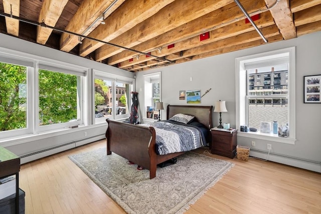 33 Commercial Wharf Unit 33A, Boston, MA 02110 - bedroom featuring a baseboard heating unit, hardwood / wood-style flooring, wood ceiling with exposed beams, and french doors