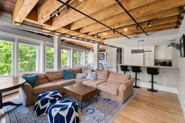 33 Commercial Wharf Unit 33A, Boston, MA 02110 - living room with rail lighting, baseboards, beamed ceiling, and light wood-style floors