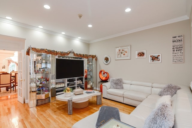 living room featuring light hardwood / wood-style floors and crown molding