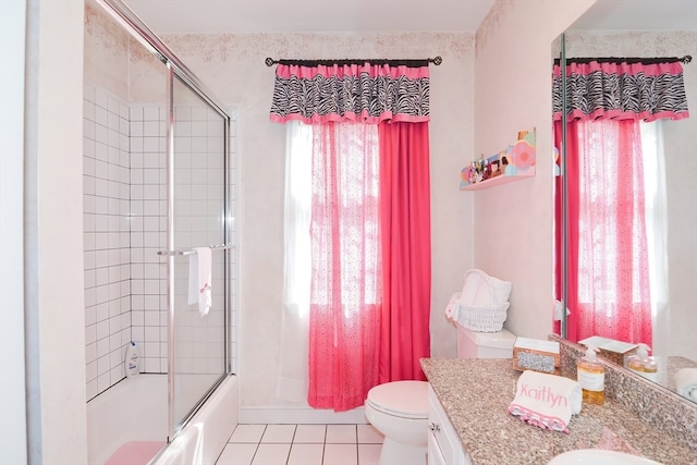 full bathroom featuring vanity, toilet, tile patterned floors, and bath / shower combo with glass door