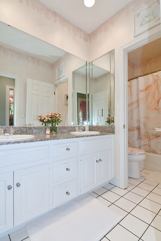 full bathroom with tile patterned flooring, toilet, shower / tub combo, and vanity