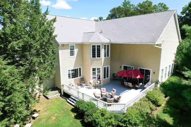 back of property featuring a yard and a deck