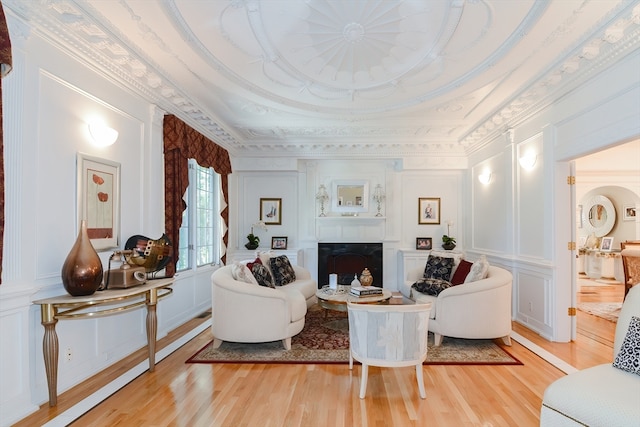 living room featuring crown molding and light hardwood / wood-style flooring