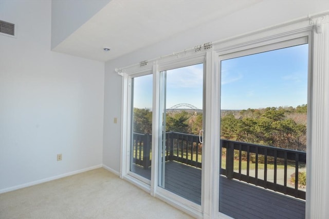 doorway featuring light colored carpet