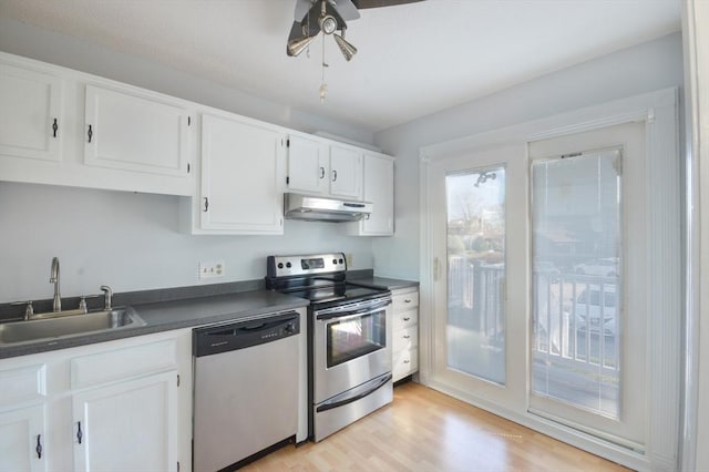 kitchen featuring ceiling fan, sink, stainless steel appliances, light hardwood / wood-style flooring, and white cabinets