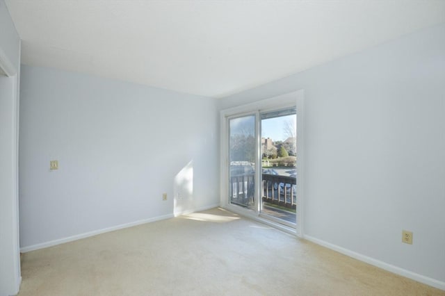 unfurnished room featuring light colored carpet