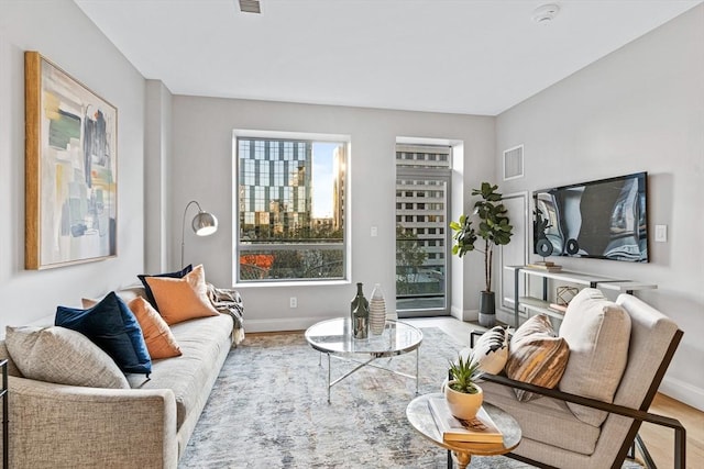 living area with visible vents and baseboards