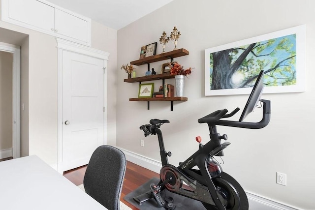 workout area with dark wood-style floors