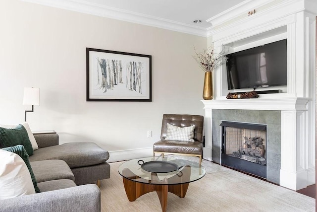 living area with ornamental molding, a tiled fireplace, and baseboards