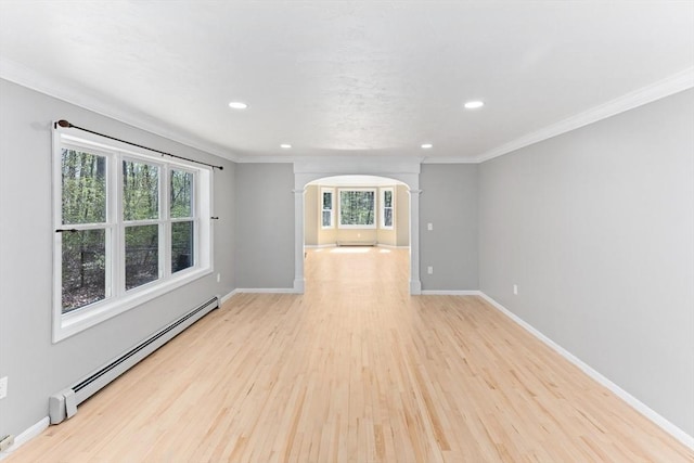 3 Centennial Dr, Blackstone, MA 01504 - spare room with crown molding, baseboards, a baseboard heating unit, arched walkways, and light wood-style flooring