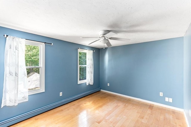 3 Centennial Dr, Blackstone, MA 01504 - spare room with a baseboard heating unit, plenty of natural light, and wood finished floors