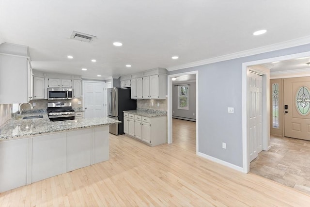 3 Centennial Dr, Blackstone, MA 01504 - kitchen with decorative backsplash, visible vents, appliances with stainless steel finishes, a sink, and a peninsula