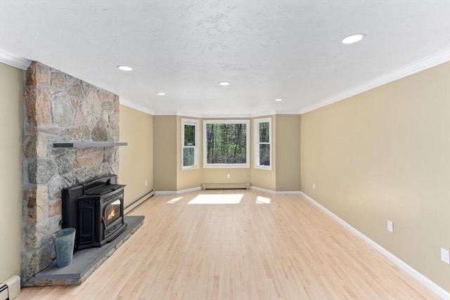 3 Centennial Dr, Blackstone, MA 01504 - unfurnished living room with crown molding, a wood stove, baseboard heating, and a baseboard heating unit