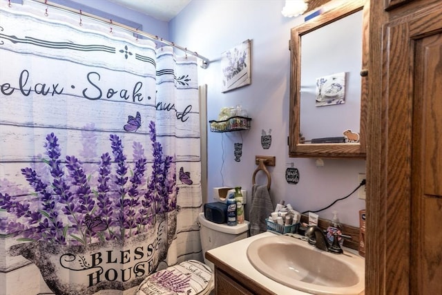 bathroom with toilet, curtained shower, and vanity