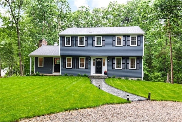 98 Old Forge Rd, Scituate, MA 02066 - colonial-style house with a chimney, a front lawn, and view of wooded area