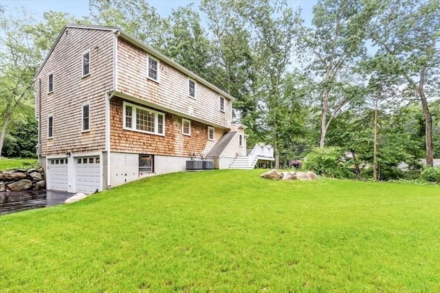 98 Old Forge Rd, Scituate, MA 02066 - back of property with a garage, driveway, a yard, and view of scattered trees