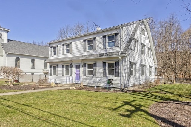 view of front of house with a front yard and fence