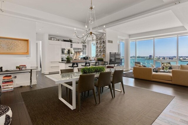 dining room with hardwood / wood-style flooring and a chandelier