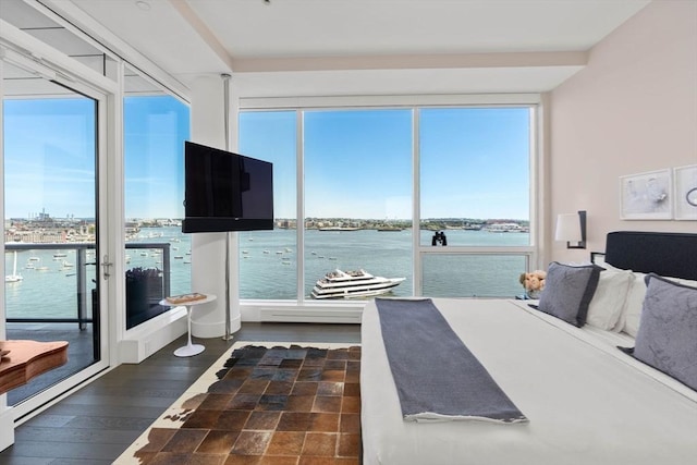 bedroom with multiple windows, access to outside, and dark hardwood / wood-style floors