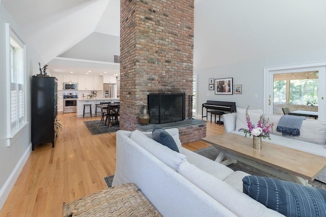 28 Marthas Rd, Edgartown, MA 02539 - living room featuring a brick fireplace, light wood-style flooring, and high vaulted ceiling