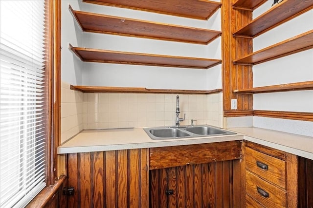 29 Tatman St, Worcester, MA 01607 - kitchen with open shelves, a sink, decorative backsplash, light countertops, and brown cabinetry