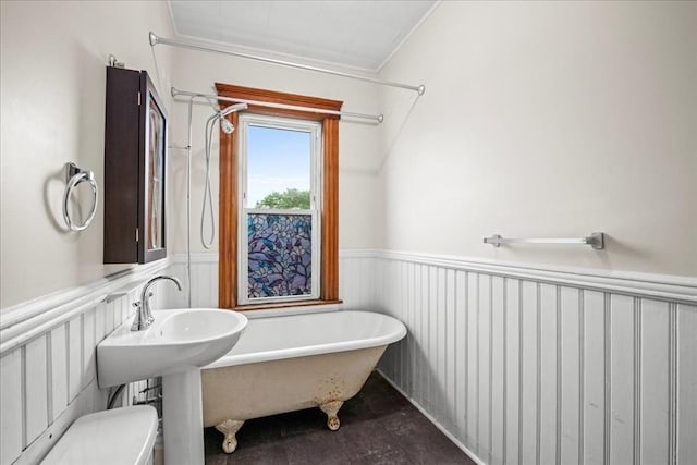 29 Tatman St, Worcester, MA 01607 - bathroom with a soaking tub, wainscoting, and toilet