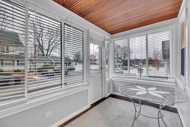 unfurnished sunroom featuring wooden ceiling