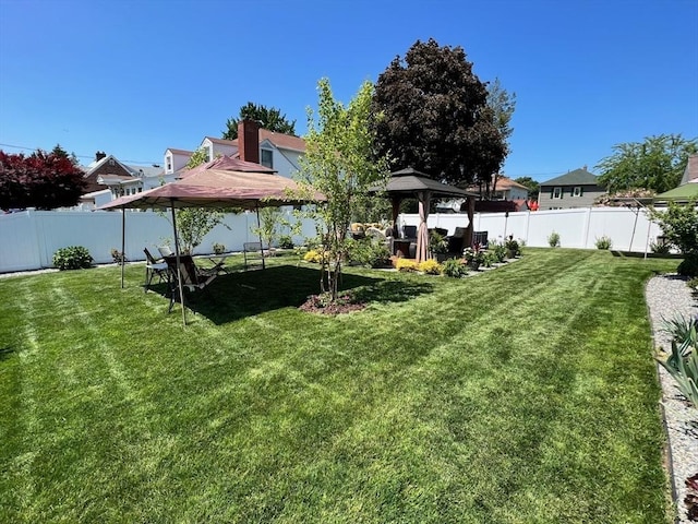 view of yard featuring a gazebo and a trampoline