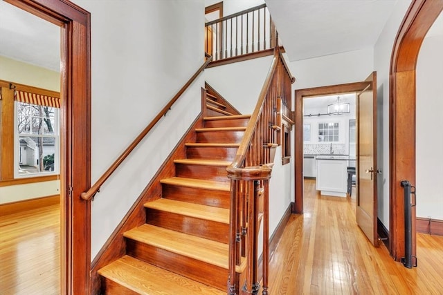 stairs featuring sink and wood-type flooring