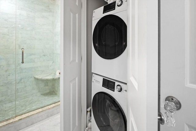 clothes washing area with stacked washer and clothes dryer