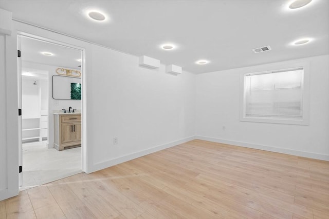 spare room with light hardwood / wood-style floors