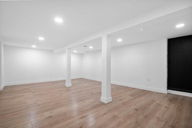 basement with light hardwood / wood-style flooring