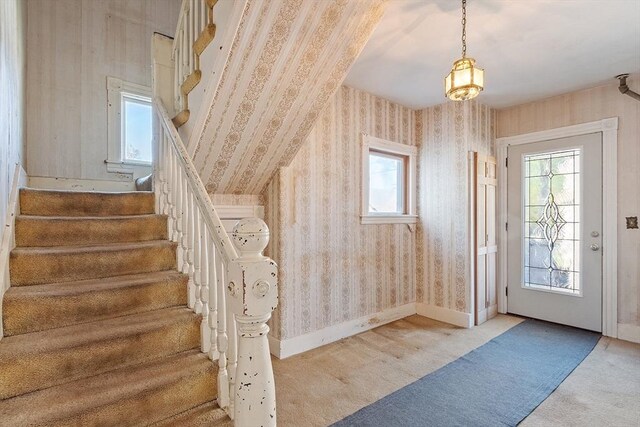 interior space featuring stairs, wallpapered walls, and plenty of natural light