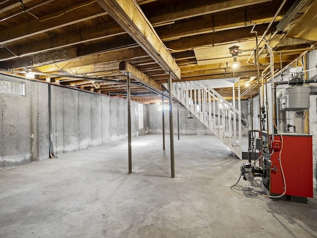 unfinished below grade area featuring stairway and a heating unit