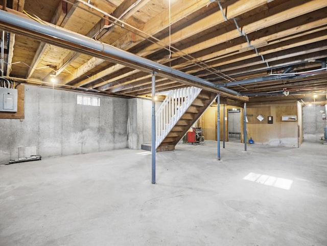 basement with stairs and electric panel