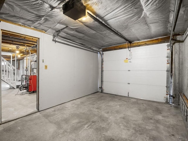 garage featuring a garage door opener and a heating unit