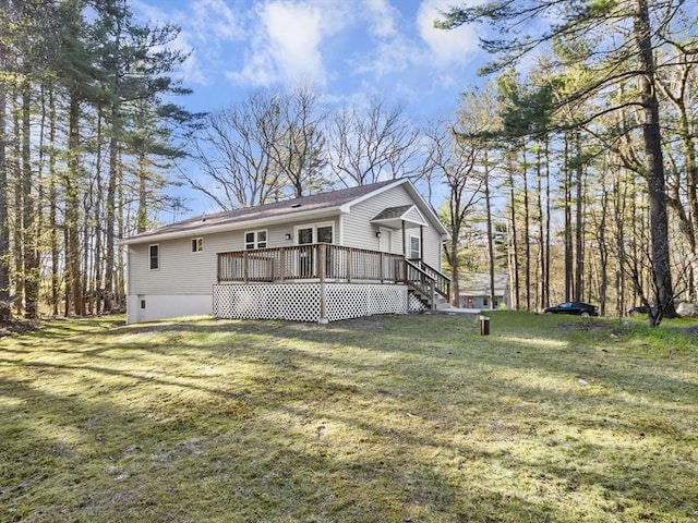 rear view of property with a yard and a deck