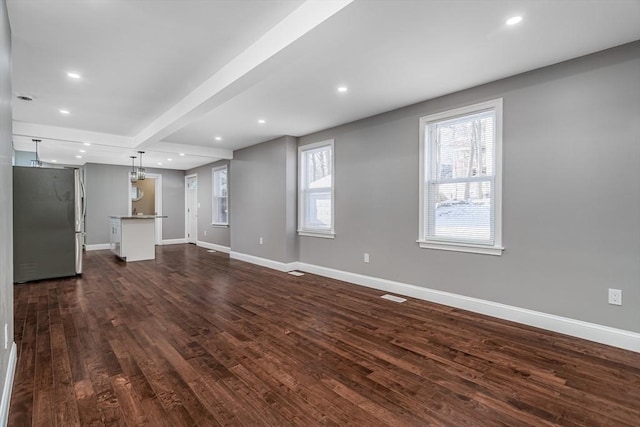 70 Sanborn St, Fitchburg, MA 01420 - unfurnished living room with baseboards, dark wood finished floors, beam ceiling, and recessed lighting