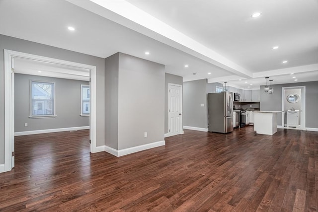 70 Sanborn St, Fitchburg, MA 01420 - unfurnished living room with dark wood-style flooring, recessed lighting, and baseboards