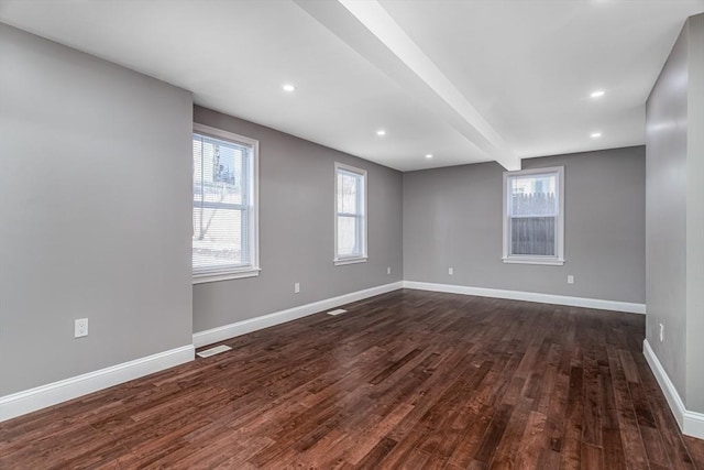 70 Sanborn St, Fitchburg, MA 01420 - unfurnished room featuring plenty of natural light, dark wood-style floors, baseboards, beamed ceiling, and recessed lighting