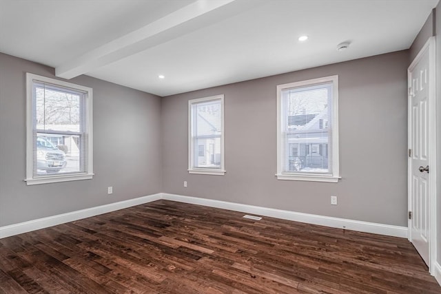 70 Sanborn St, Fitchburg, MA 01420 - empty room featuring healthy amount of natural light, dark wood finished floors, baseboards, beamed ceiling, and recessed lighting