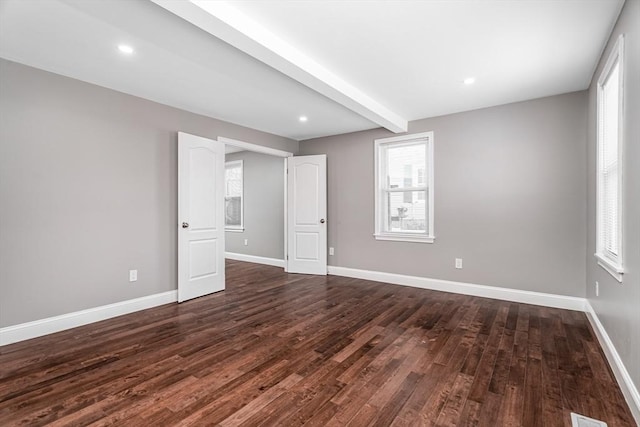 70 Sanborn St, Fitchburg, MA 01420 - empty room featuring dark wood finished floors, baseboards, beamed ceiling, and recessed lighting