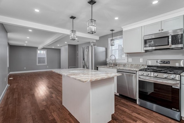70 Sanborn St, Fitchburg, MA 01420 - kitchen with stainless steel appliances, a sink, baseboards, light stone counters, and plenty of natural light